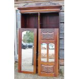 An Edwardian mahogany wardrobe with carved panel doors enclosed internal drawers over one long