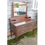 A mahogany dressing table with two short and one long drawer, on square tapering supports, 41 3/4"
