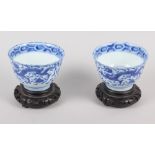 A pair of Chinese blue and white tea bowls, decorated dragons and phoenix with four character