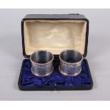 A pair of silver napkin rings with engraved decoration, in box, 2oz troy approx