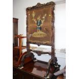 A 19th century carved oak framed firescreen with embroidered panel, Winchester College Arms, 21"