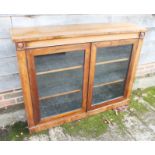 A 19th century rosewood display cabinet/bookcase enclosed two panelled doors, on block base, 14"