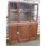 An Art Deco design mahogany display cabinet, the upper section enclosed lattice glazed doors over