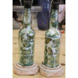 A pair of Victorian transfer decorated glass bottles, now converted as table lamps, 13" high