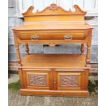 A carved walnut two-tier buffet table with raised back and single drawer over two carved doors, on