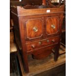 A late Georgian mahogany tray top bedside cupboard/commode, fitted two drawers, central recess and