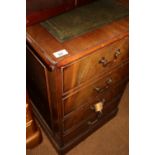 A mahogany two drawer filing cabinet with tooled green leather lined top