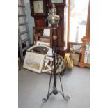 An Edwardian brass oil lamp, on black metal stand with tripod base, 60" high