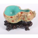 A Chinese porcelain gourd-shaped brush washer with turquoise interior, 3 1/2" long, on carved