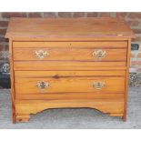 A pine chest of two drawers, 31" wide, and a wicker hamper