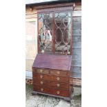 An Adam revival mahogany bureau bookcase, the upper section enclosed lattice glazed doors over