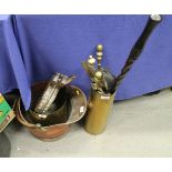 A copper coal helmet, two brass shell cases, a set of brass fire implements and a pair of bellows