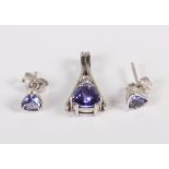 A diamond and tanzanite pendant, mounted in white metal, stamped 750, and a pair of tanzanite and