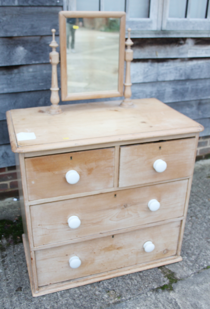 A pine dressing chest of two short and two long drawers with white bun handles, 40" wide