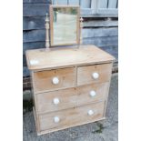 A pine dressing chest of two short and two long drawers with white bun handles, 40" wide