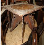 An Eastern carved wood square top occasional table and a carved oak drop leaf Sutherland table