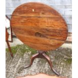 A 19th century provincial oak circular tilt top occasional table, on bird cage turned column and