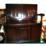 A monk's oak bench with moulded panels, on bun feet, 39" wide