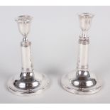 A pair of silver plated adjustable candlesticks, on circular bases, stamped "Morton's Patent"