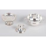 A silver bonbon dish with raised base and pierced decoration, a silver two-handled sugar bowl and an