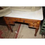 A walnut and marble topped washstand, fitted four short drawers, on turned and fluted supports,