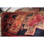 A Persian Meshkin runner in shades of orange, brown and red on a dark blue ground, 108" x 35" approx