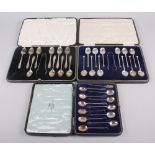 A cased set of twelve silver coffee bean spoons, a cased set of twelve silver coffee spoons and