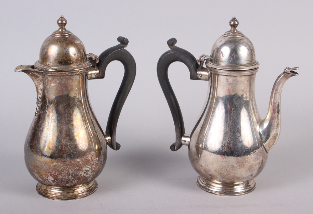 An Elkington & Co silver coffee pot with ebonised handle and a matching hot water pot, 25.3oz troy