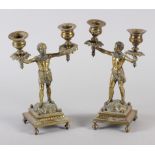 A pair of 19th century brass Nubian figure two-light candlesticks, on square bases, 9" high