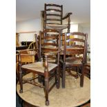 A set of eight ash and oak ladder back dining chairs with rush envelope seats, on turned and