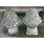 A pair of cast stone pinecone-shaped garden finials
