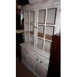 A grey painted and grained dresser, the upper section enclosed two wire panel doors over two drawers