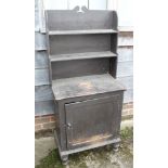 A black painted side cabinet, fitted open shelves over cupboard, on turned supports, 24" wide x