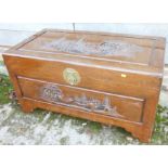 A carved camphor wood chest with landscape panels and interior fitted tray, 40" wide x 20" deep x