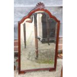 A carved mahogany arch top framed wall mirror with bevelled plate, 23 1/2" x 13 1/2"