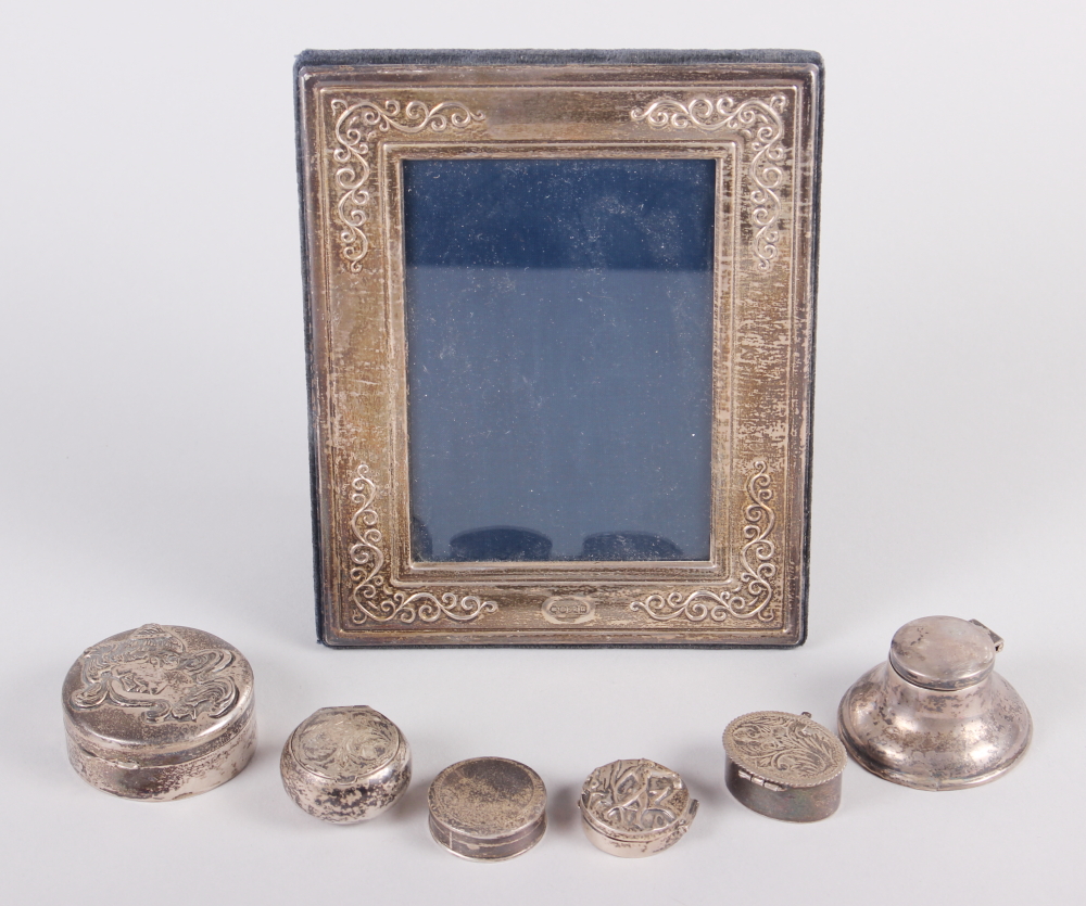 A silver photograph frame, five silver pill boxes, various, a silver capstan inkwell and four silver