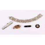 A Victorian gilt metal knot brooch set garnet, an Art Deco style paste set bracelet, a mother-of-