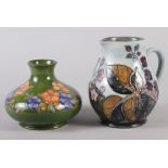 A Moorcroft Sally Tuffin design floral squat vase, 4" high, and a Moorcroft blackberry jug, 5 1/2"