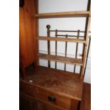 A waxed pine dresser with open shelves over three drawers and three cupboards, on block base, 62"