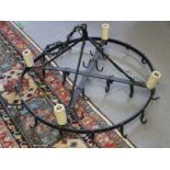 A late 19th century wrought iron circular game hanger, now converted as a ceiling light pendant, 34"