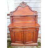 A late Victorian mahogany serpentine front chiffonier, fitted one drawer over cupboards, on block