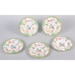 Five late 19th century tea plates with floral decoration and green borders, 5 1/2" dia
