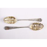 A pair of Hester Bateman berry spoons with engraved dog nose handles, bowls embossed fruit, London