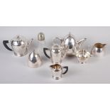 A silver plated four-piece teaset, another similar three-piece teaset, a pair of sugar tongs and a