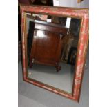 A rectangular wall mirror, bevelled plate 19 1/2" x 15 1/4", in Liberty peacock feather frame, a