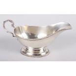 A silver sauce boat with gadrooned borders, 5.7oz troy approx