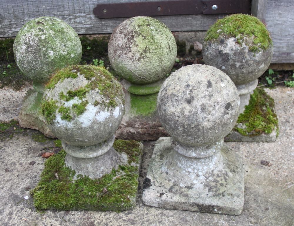 Five cast stone garden finials, on square bases, tallest 10 1/2" high