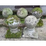 Five cast stone garden finials, on square bases, tallest 10 1/2" high