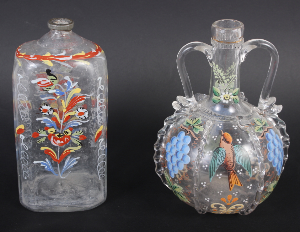 A 19th century glass bottle with carrying handles and enamelled bird and fruit decoration, 6 1/4"