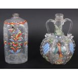 A 19th century glass bottle with carrying handles and enamelled bird and fruit decoration, 6 1/4"